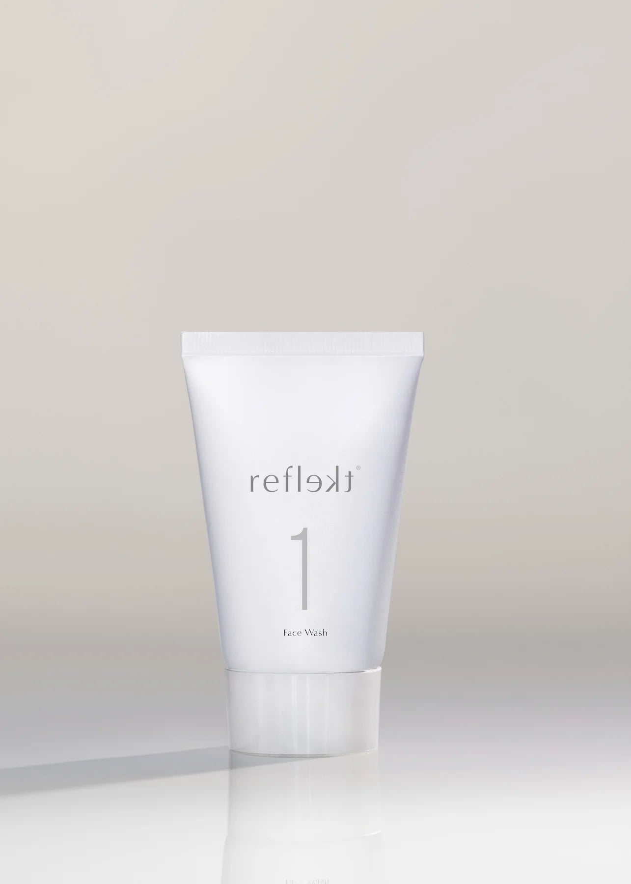 White skincare product tube labeled &