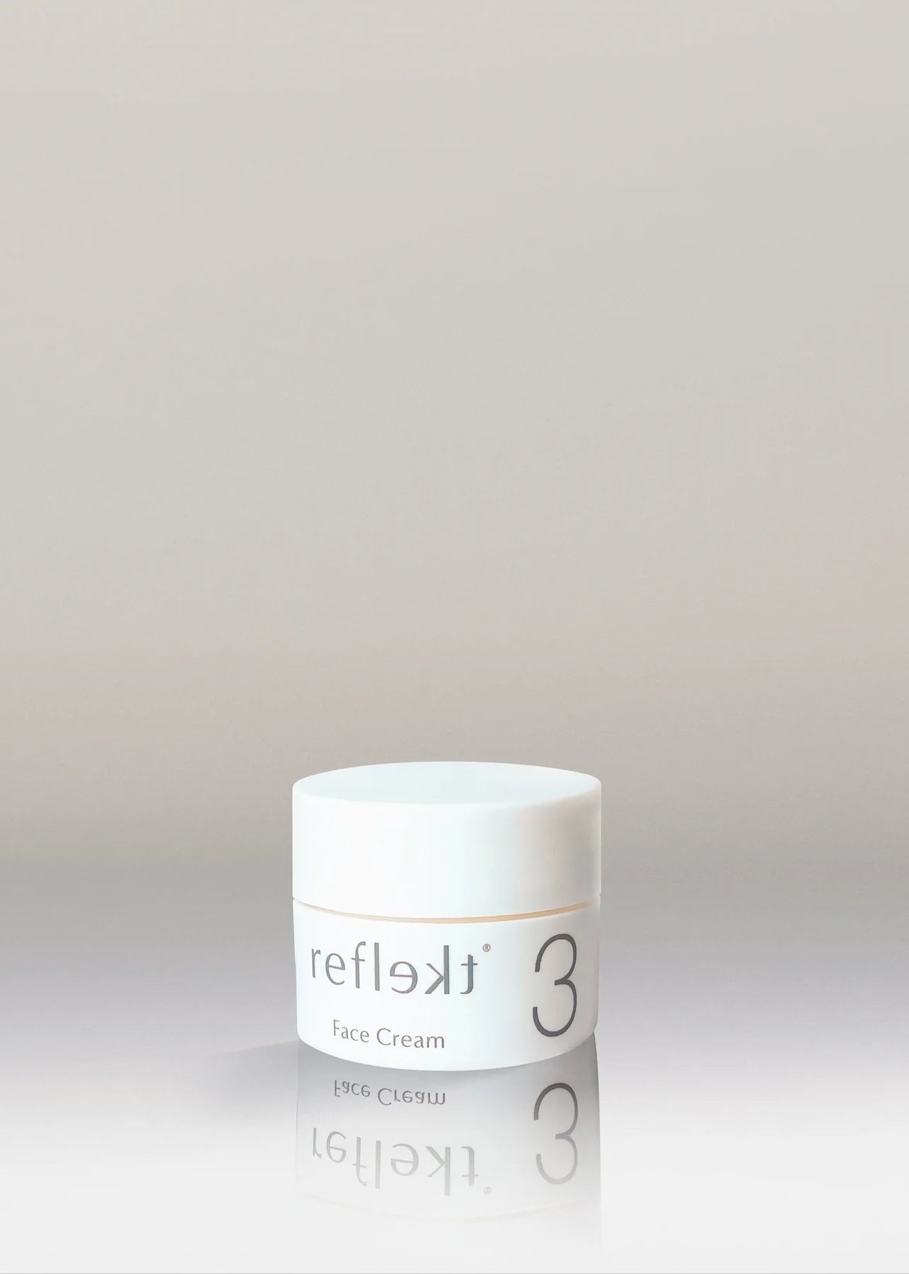 White jar of reflek3 face cream on a light gray background