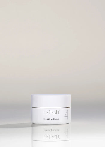 A white tub of the eye and lip cream against a nude background