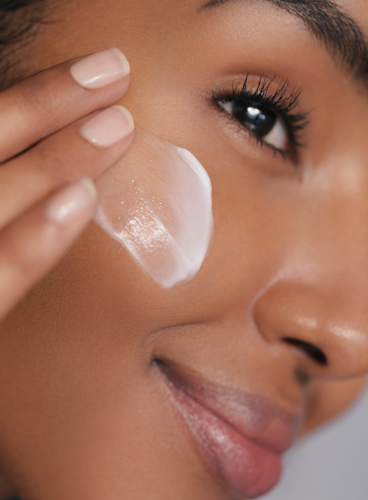 Woman applying Reflekt 3 Renewing Hydrating Face Cream to face, demonstrating lightweight hydration