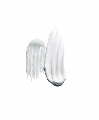 Close-up of a white cream with a comb on a white background
