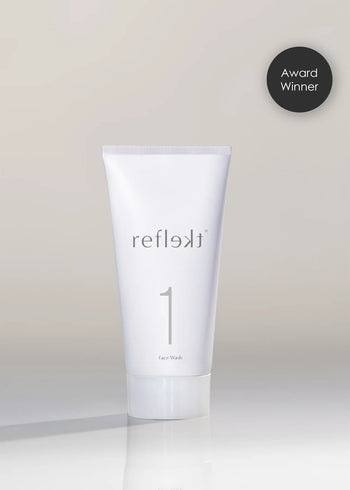 Tube of reflekt1 Face Wash on a light gray background with an &